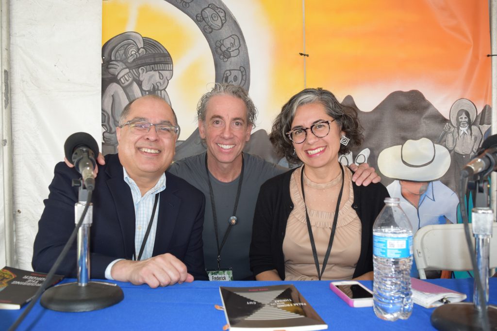 Representing Camino del Sol at the festival, authors Daniel Olivas, Frederick Aldama, and Vickie Vértiz take a moment to pose for photographers on the Pima County Libraries Nuestra Raices stage.