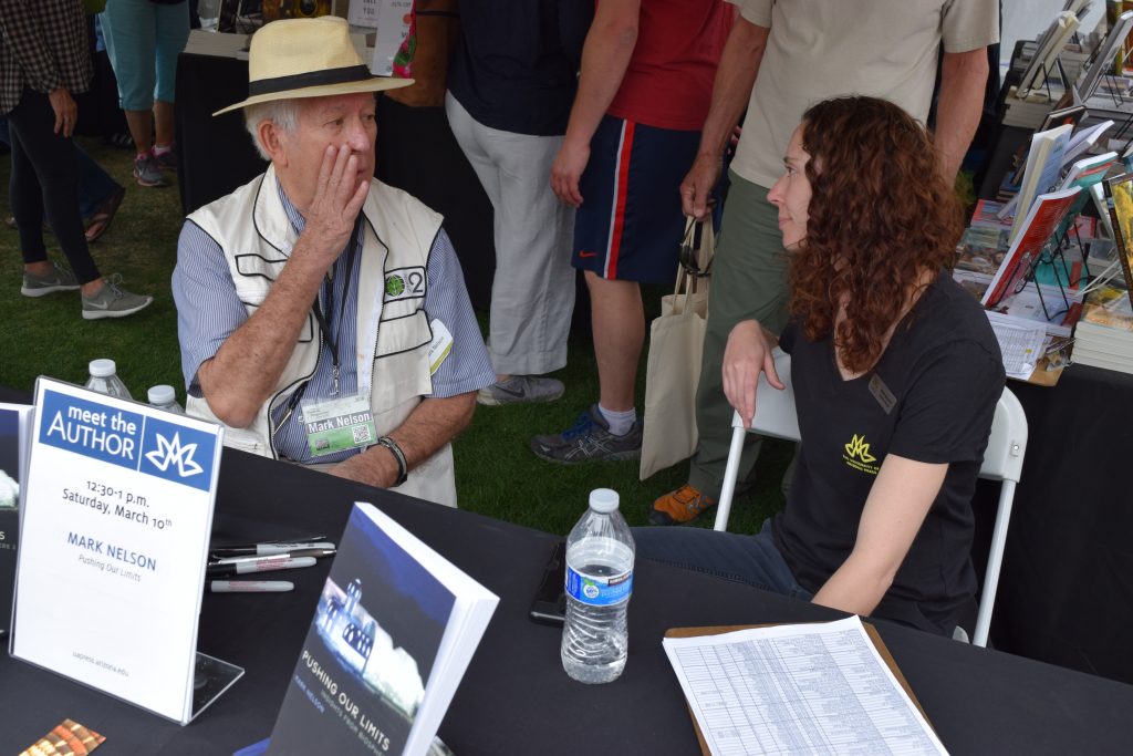 Mark Nelson, one of the eight-person crew for the first two-year closure experiment in Biosphere 2, teases UA Press publicity manager Rose Brandt at his booth signing Saturday afternoon.