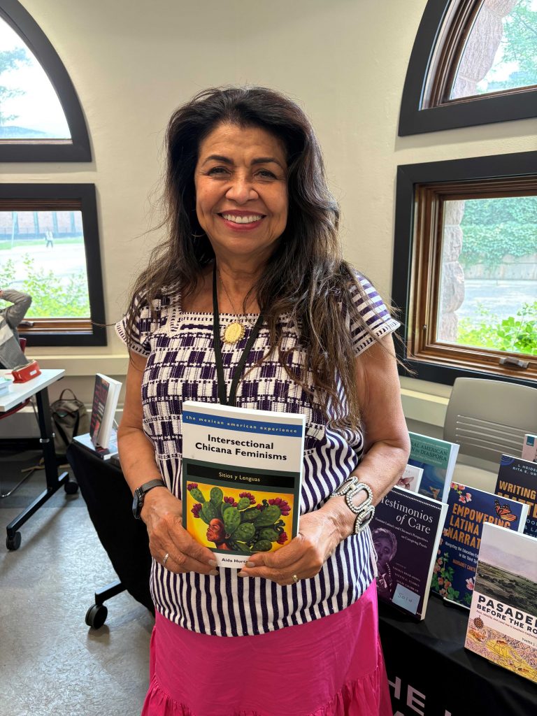 Authors and editors Aída Hurtado, Irene Lara, and Vanessa Fonseca-Chávez gather at the University of Arizona Press booth during the 2026 MALCS Summer Institute