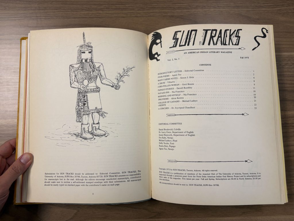 Open book spread with a line drawing of a ceremonial figure on the left page and the Sun Tracks Fall 1975 table of contents on the right page.